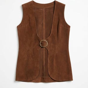 May include: A brown suede vest featuring a deep V-neck and a gold-coloured ring closure. The sleeveless vest has a tailored fit. The text "LEATHERMED FORGE" is visible at the top of the image.