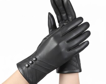 May include: A pair of black leather gloves with a quilted cuff design and three decorative buttons. The gloves have a smooth, sleek appearance. The brand name "LEATHERMED FORGE" is displayed in the top left corner of the image.
