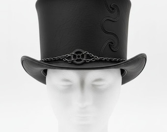 May include: A black top hat with a decorative gear and chain detail around the brim. The hat has a curved design on the side and is displayed on a white mannequin head. The logo "LEATHERMED FORGE" is in the top right corner.