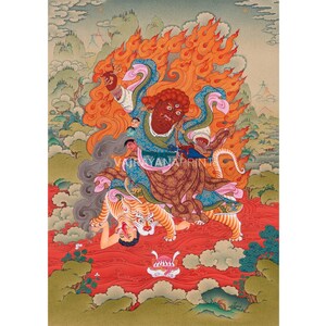 May include: A vibrant, detailed painting depicting a deity with a fiery aura, multiple arms, and a fierce expression. The deity is riding a tiger over a red landscape. The artwork features the text "VAJRAYANAPRINT" and is set against a backdrop of mountains and clouds.
