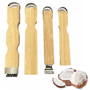 May include: Four wooden coconut graters with metal grating blades. The graters have light brown wooden handles and are displayed with a halved coconut, shredded coconut, and coconut pieces. The graters are designed for preparing fresh coconut.