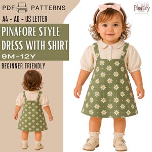 May include: A young child wearing a green pinafore dress with white daisy patterns over a cream-colored shirt. The dress has suspender straps. The image includes the text "PINAFORE STYLE DRESS WITH SHIRT" and "9M-12Y".