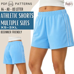 May include: Light blue athletic shorts with an elastic waistband and a white vertical stripe along the side. The text reads: PDF PATTERNS, A4 - A0 - US LETTER, ATHLETIC SHORTS, MULTIPLE SIZES, XS-3XL, BEGINNER FRIENDLY. The brand logo says Pleatsy.