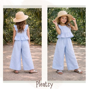 May include: A light blue linen two-piece outfit for children, featuring a ruffled top and wide-leg pants. The outfit is paired with a straw hat and silver sandals. The word "Pleatsy" is displayed at the bottom of the image.