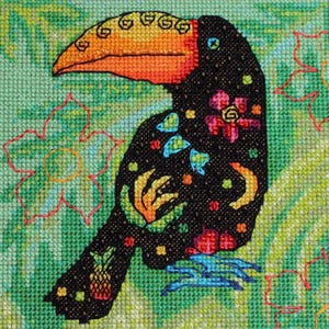 May include: A colorful cross-stitch design of a toucan bird. The bird is black with a large orange and yellow beak. It is decorated with floral and geometric patterns in various colors. The background is green with floral accents.