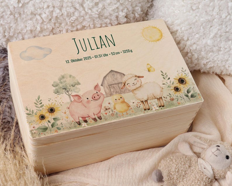 May include: A wooden keepsake box with a farm scene illustration. The box features a pig, sheep, chick, barn, sunflowers, and the name "Julian" with birth details. The design includes a sun, cloud, and butterfly, all in soft watercolor tones.