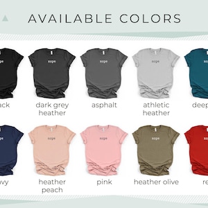 May include: A display of ten t-shirts in various colors, each with the word "nope" printed in a small font. Colors include black, dark grey heather, asphalt, athletic heather, deep teal, navy, heather peach, pink, heather olive, and red. The text "AVAILABLE COLORS" is at the top.