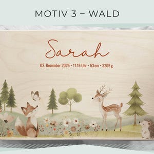 May include: A wooden box with a forest-themed illustration. The design includes a fox, deer, hedgehog, trees, and flowers. The name "Sarah" is written in cursive, along with the date, time, and measurements: 53 cm and 3205 g.