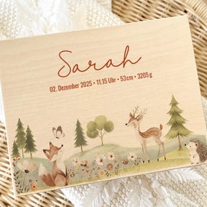 May include: Wooden keepsake box with a woodland scene featuring a fox, deer, and hedgehog. The box is personalized with the name "Sarah" and birth details: December 2, 2025, 11:15 AM, 53cm, and 3205g.