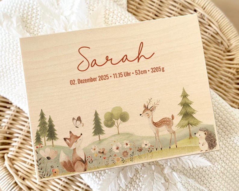 May include: Wooden keepsake box with a woodland scene featuring a fox, deer, and hedgehog. The box is personalized with the name "Sarah" and birth details: December 2, 2025, 11:15 AM, 53cm, and 3205g.