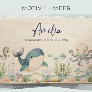 May include: Wooden box with a watercolor illustration of a whale, seahorse, octopus, and fish. The name "Amelia" is written in cursive, along with the date, time, length (50 cm), and weight (3190 g). The box has a light wood grain.