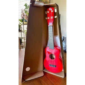 May include: A white ceramic mug with a black handle and the text "But First, Coffee" in a handwritten style. The mug is on a white surface. The mug is 4 inches tall.