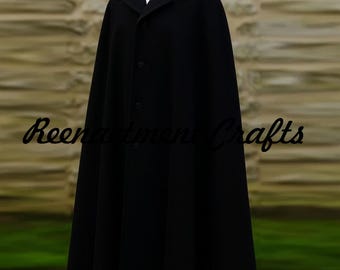 May include: A long black cape with a button-up front and a collar. The cape is made of a dark fabric and has a flowing design. The text "Reenactment Crafts" is visible in the image.