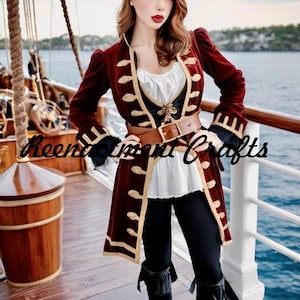 Puede incluir: Abrigo de pirata de terciopelo burdeos con ribetes y botones dorados, combinado con una blusa blanca, un corsé negro y pantalones negros. Un cinturón de cuero marrón ciñe la cintura. Incluye el texto "Reenactment Crafts".