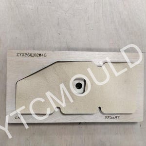 May include: A wooden die-cut mold with a unique shape, featuring a central circular opening and a rectangular form. The dimensions are 225x97. The text "ZYX26010204G" and "CX" are visible. The logo "YTCMOULD" is also visible.