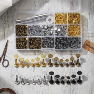 May include: A set of three ceramic mugs with a speckled, matte finish. The mugs are in cream, light grey, and dark grey. Each mug has a simple, minimalist design, ideal for coffee or tea.