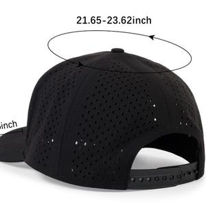 May include: Black baseball cap with a perforated design. The cap has a curved brim measuring 2.95 inches, a height of 4.33 inches, and a circumference of 21.65-23.62 inches. It features an adjustable strap at the back.