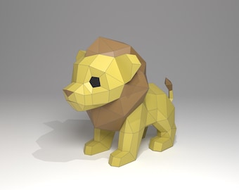 May include: A geometric papercraft lion figurine. The lion is primarily yellow with a brown mane and a small tail. The eyes are black. The design is made up of many flat, angular planes, giving it a polygonal appearance.
