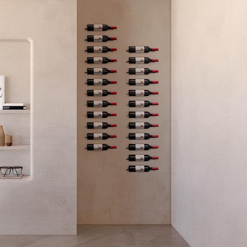 May include: A wall-mounted wine rack displaying numerous wine bottles. The bottles are arranged in rows, with their labels visible. The rack is mounted on a neutral-colored wall, creating a minimalist and modern aesthetic. The bottles are dark with red tops.