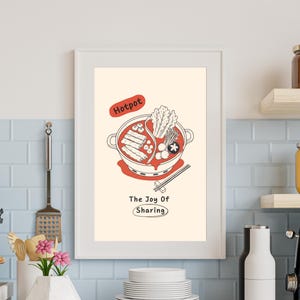 Puede incluir: Una lámina artística enmarcada con una ilustración de líneas de un hotpot lleno de ingredientes. El texto "Hotpot" aparece en un óvalo rojo arriba, y "The Joy Of Sharing" está impreso debajo en negro, con la palabra "Sharing" en un óvalo.