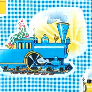 May include: A blue toy train with a clown sitting on top. The train has a large wheel and a smokestack with a face. The train is on a track and there is a yellow sun shining behind it.