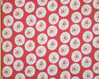 May include: Red fabric with a white polka dot pattern and a repeating design of white circles with pink roses and green leaves.