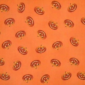 May include: Orange fabric with a repeating pattern of orange jack-o'-lantern faces.