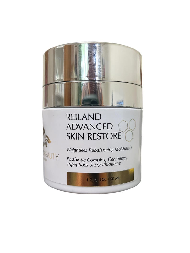 May include: A white and silver jar of Reiland Advanced Skin Restore moisturizer. The label includes the text "Weightless Rebalancing Moisturizer" and "1.7 fl oz / 50 mL". The jar has a silver lid and a white base with black text.