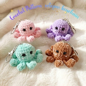 May include: Four crochet octopus keychains in pink, purple, mint green, and brown. Each plush octopus features black safety eyes, small white fangs, and a silver metal lobster clasp. The text Crochet Pattern octopus keychain is visible.