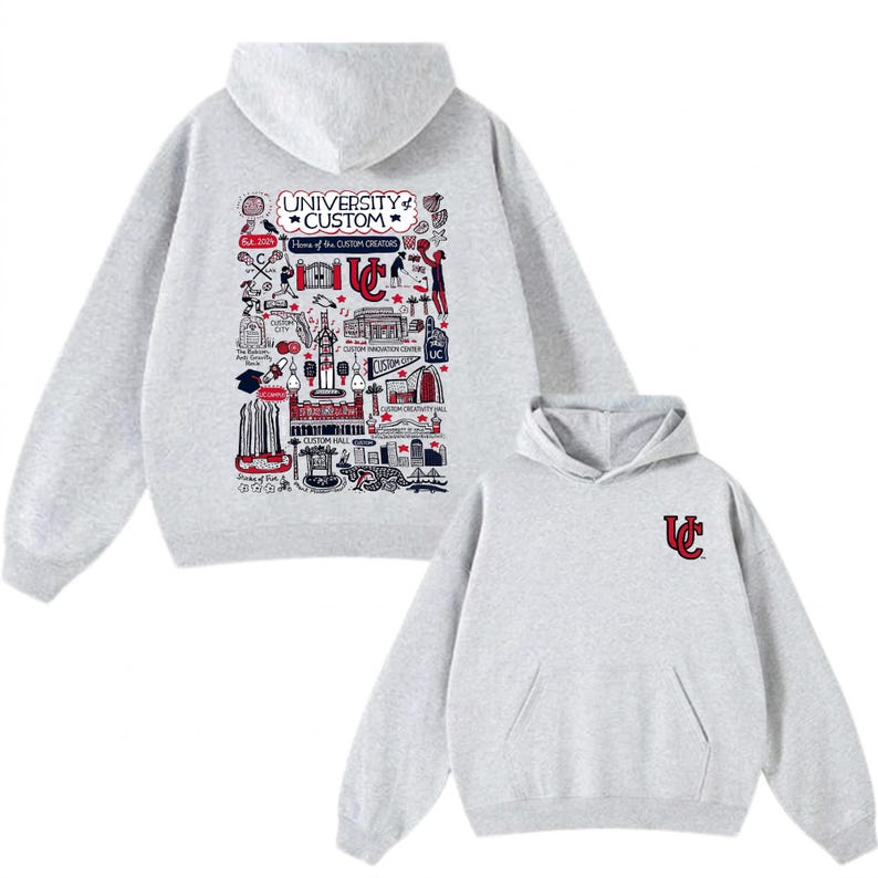 Puede incluir: Una sudadera con capucha de color gris claro con un bolsillo delantero y una capucha. La parte trasera de la sudadera con capucha presenta un gr&aacute;fico detallado con el texto "UNIVERSITY CUSTOM" y varias ilustraciones en rojo, blanco y negro. La parte delantera tiene un peque&ntilde;o logotipo "UC".