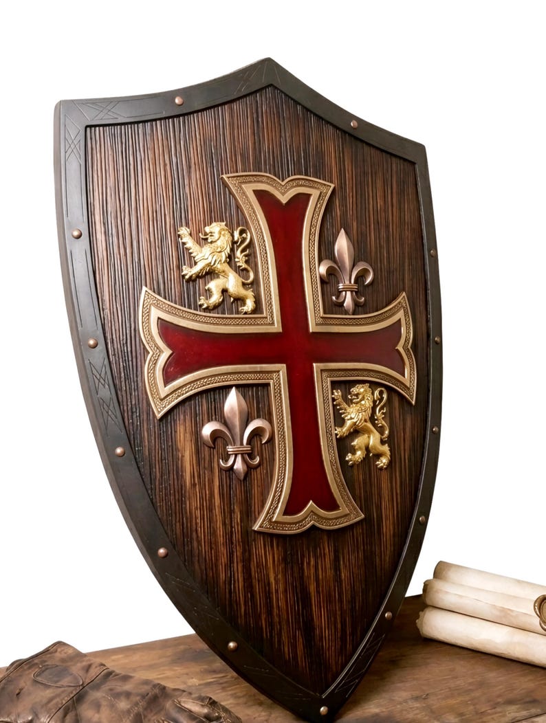 May include: A pointed shield with a dark brown wood-grain finish, featuring a large central cross in deep red with gold-toned trim. The shield displays two gold-toned rampant lions and two metallic fleur-de-lis emblems, secured by small rivets.