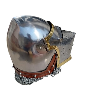May include: A polished steel helmet with brass detailing and a leather neck guard. The helmet has a riveted chainmail lower edge and a perforated visor. This medieval-style helmet is designed for protection.