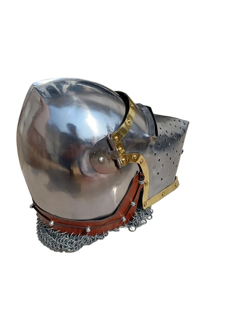 May include: A polished steel helmet with brass detailing and a leather neck guard. The helmet has a riveted chainmail lower edge and a perforated visor. This medieval-style helmet is designed for protection.