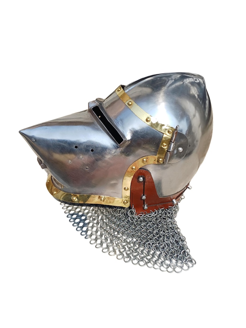 May include: A shiny steel helmet with a pointed visor, brass detailing, and a chainmail aventail. The helmet has a leather strap and rivets. This medieval-style helmet is suitable for historical reenactment or display.