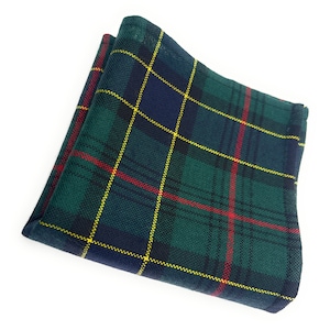May include: A folded pocket square in a green, navy, and yellow tartan pattern. The fabric has a woven texture, with red lines. The pocket square is neatly folded, displaying the traditional plaid design. A classic accessory for formal occasions.