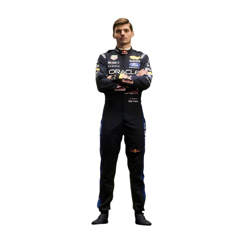 May include: A person wearing a black racing suit with sponsor logos, including "Oracle" and "Mobil 1". The suit has blue and red accents and the Red Bull logo. The person is standing with arms crossed.