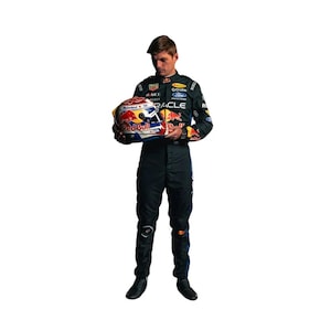 May include: A person in a black racing suit holding a Red Bull racing helmet. The helmet is white, red, and blue with sponsor logos. The suit has sponsor logos and the Red Bull logo.