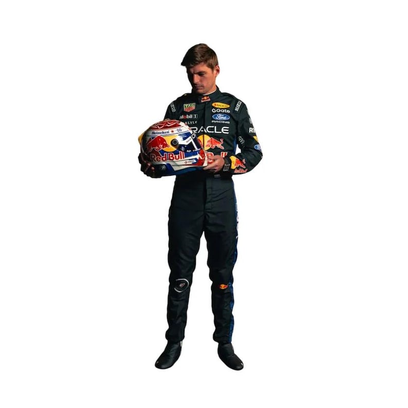 May include: A person in a black racing suit holding a Red Bull racing helmet. The helmet is white, red, and blue with sponsor logos. The suit has sponsor logos and the Red Bull logo.