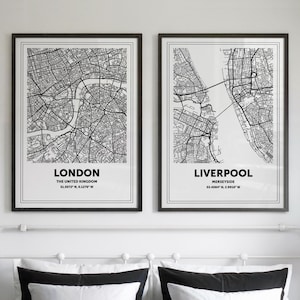 May include: Two framed black and white city map prints. One print features London, The United Kingdom, and the other features Liverpool, Merseyside. Each map has a white border and black frame. The London print includes the coordinates 51.5072° N, 0.1276° W.