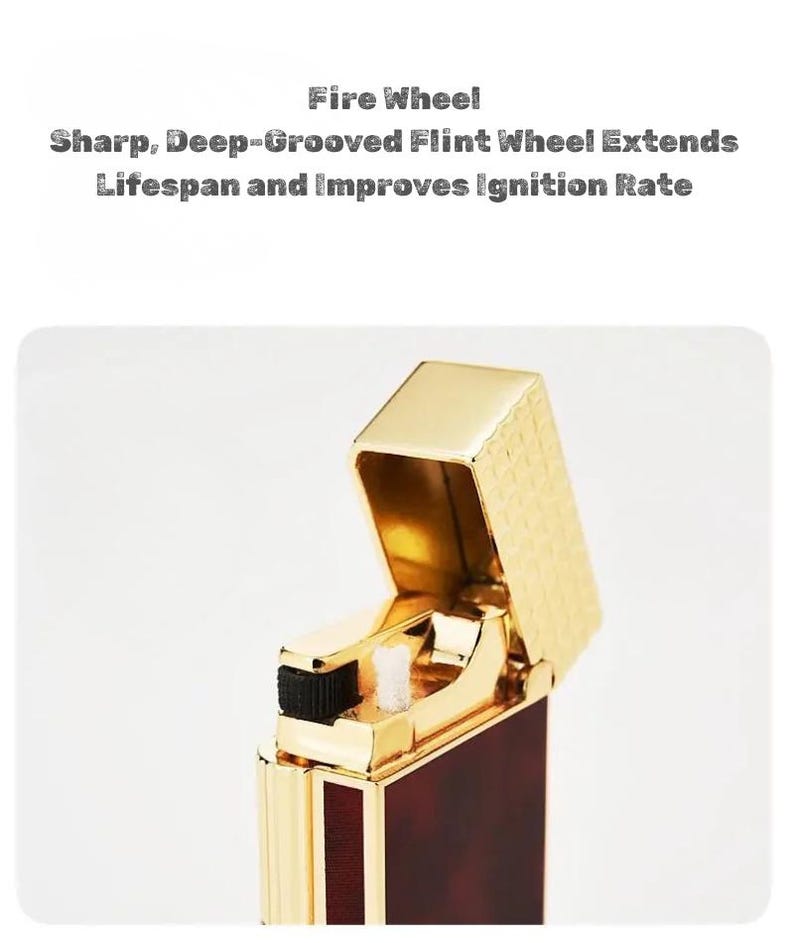 May include: A gold-colored lighter with a rectangular body and a flip-top lid. The lighter has a dark red and gold patterned design on the body. The text "Fire Wheel" and other text is visible on the image.