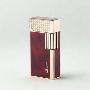May include: A gold and burgundy lighter with the word "Derui" in cursive script. The top of the lighter has a textured, geometric pattern. The body of the lighter is burgundy with a marbled effect.