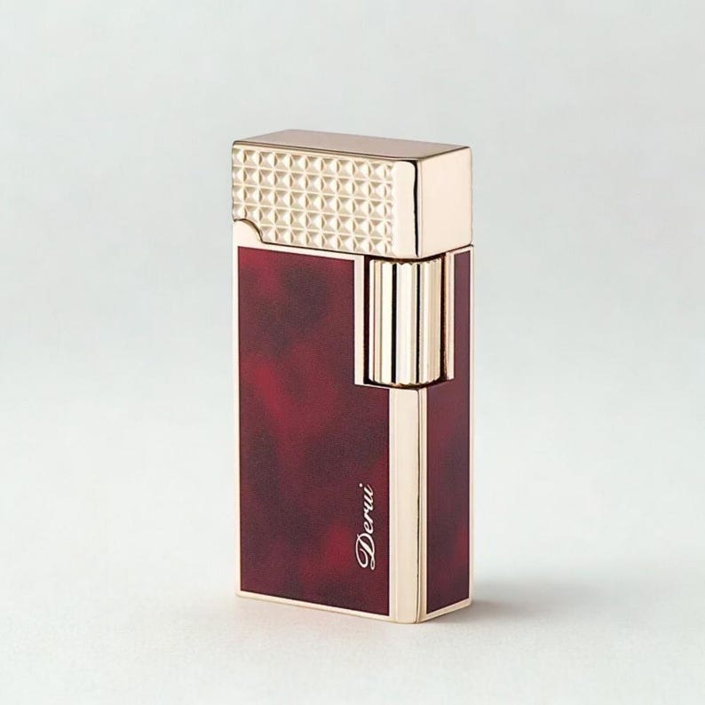 May include: A gold and burgundy lighter with the word "Derui" in cursive script. The top of the lighter has a textured, geometric pattern. The body of the lighter is burgundy with a marbled effect.