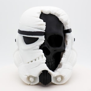 May include: A set of three ceramic mugs with a speckled, matte finish. The mugs are in shades of cream, light brown, and dark brown. Each mug has a simple, minimalist design, perfect for coffee or tea.