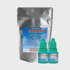 May include: A silver pouch and two small green Opticlears eye drop bottles. The bottles have white and blue labels with product information. The pouch has a blue and white label with product details.