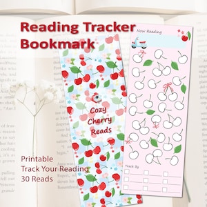 May include: Two rectangular reading tracker bookmarks. The left bookmark features a blue and white checkered pattern with red cherries, green leaves, and the text Cozy Cherry Reads. The right bookmark is pink with cherry outlines and Now Reading text.