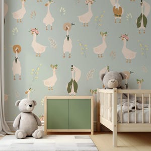 May include: A nursery scene with a light green wall featuring a repeating pattern of geese wearing hats and floral accents. A wooden crib, a green cabinet, and a gray teddy bear are in the room, creating a whimsical atmosphere.