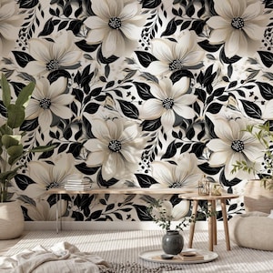 May include: A floral wallpaper design featuring large, cream-colored flowers with black centers and black leaves. The flowers are set against a cream background. The room is decorated with plants and wooden furniture.