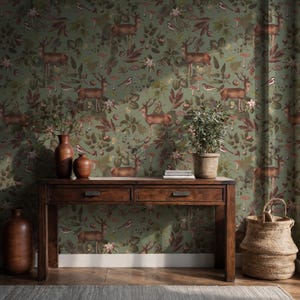 May include: A room featuring a green wallpaper with a repeating pattern of deer, birds, mushrooms, and foliage. A dark wooden console table with two drawers, vases, and a potted plant sits in front of the wallpaper. A woven basket is on the floor.