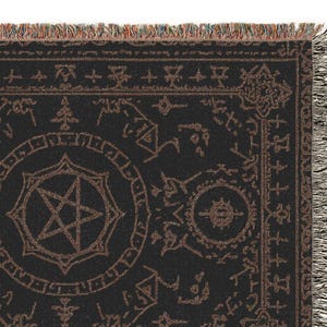 May include: Black and brown woven throw blanket with a pentagram and other occult symbols. The blanket has a rectangular shape with fringed edges. The design features a central pentagram within a circle, surrounded by various esoteric symbols.