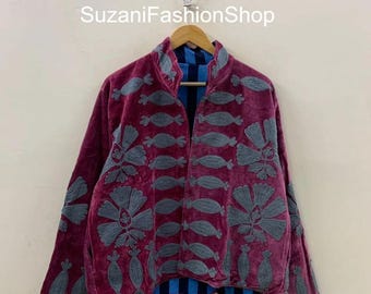 May include: A burgundy velvet jacket with gray embroidered floral and teardrop designs. The jacket has a high collar and long sleeves. The inside lining is blue and black striped. The text "SuzaniFashionShop" is visible.